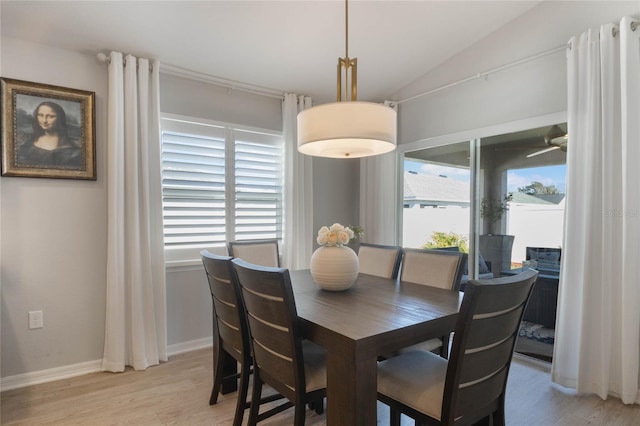 dining space with lofted ceiling and light wood-type flooring