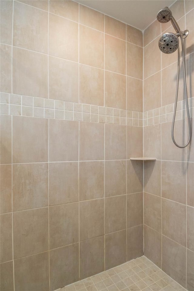 bathroom with a tile shower