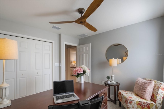 carpeted office featuring visible vents and ceiling fan