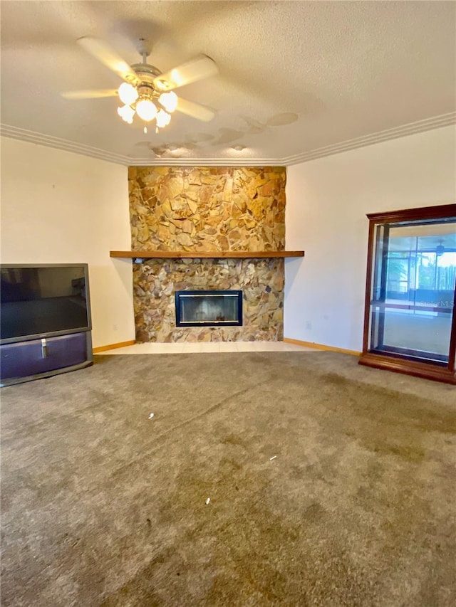 unfurnished living room featuring a stone fireplace, carpet flooring, crown molding, a textured ceiling, and ceiling fan