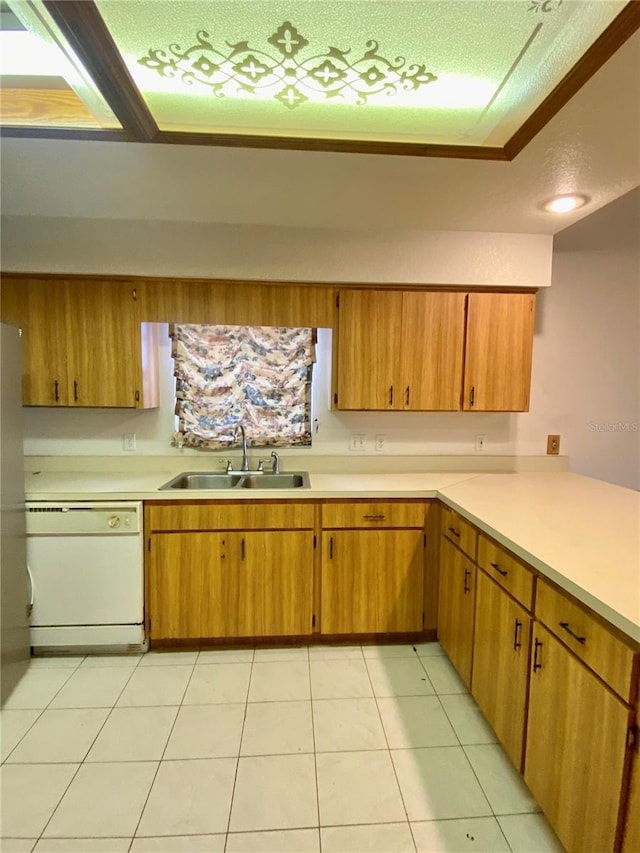 kitchen with sink, dishwasher, light tile patterned floors, and a textured ceiling