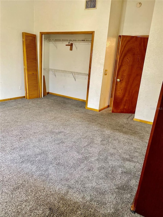 unfurnished bedroom with carpet floors and a closet