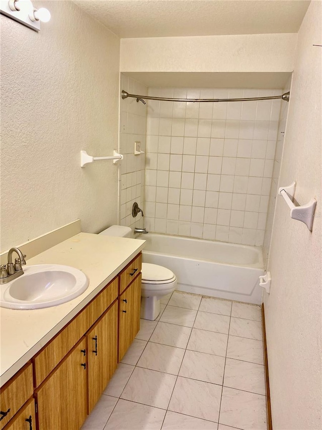 full bathroom featuring vanity, toilet, tile patterned floors, and tiled shower / bath combo