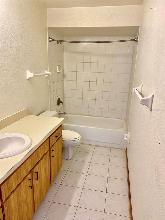 full bathroom with vanity, toilet, tile patterned floors, and tiled shower / bath combo