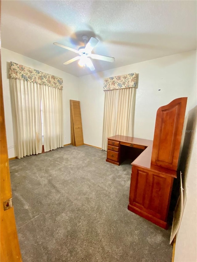 unfurnished room featuring ceiling fan, a textured ceiling, and carpet flooring