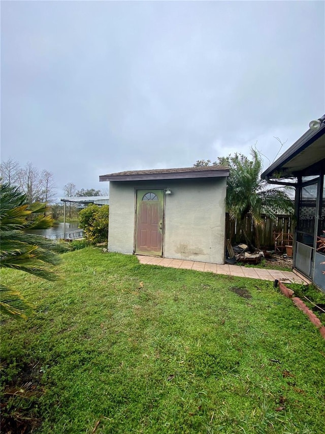 view of outbuilding featuring a yard and a water view