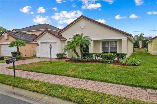 view of front of home featuring a garage and a front lawn