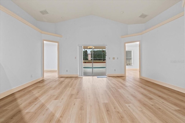 unfurnished living room with high vaulted ceiling and light wood-type flooring