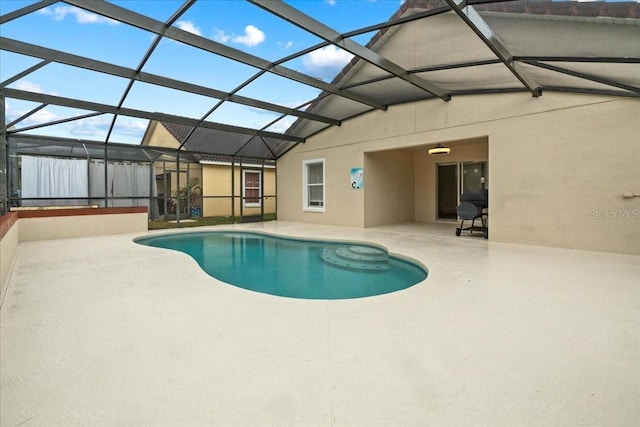 view of pool featuring a patio and glass enclosure