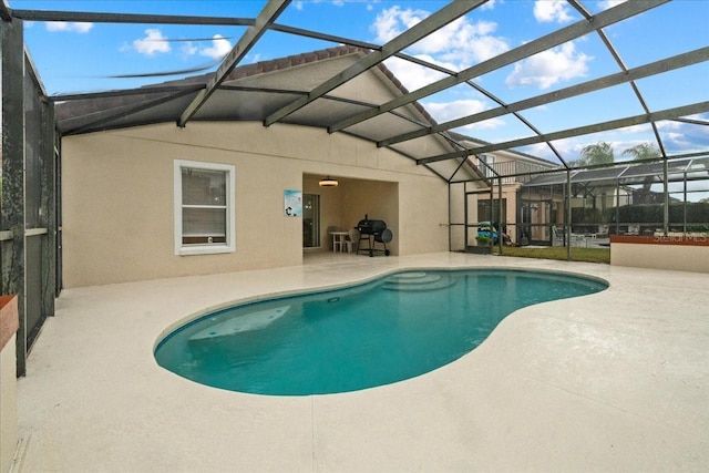 view of pool with a patio area and a lanai