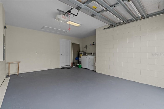 garage with a garage door opener and separate washer and dryer