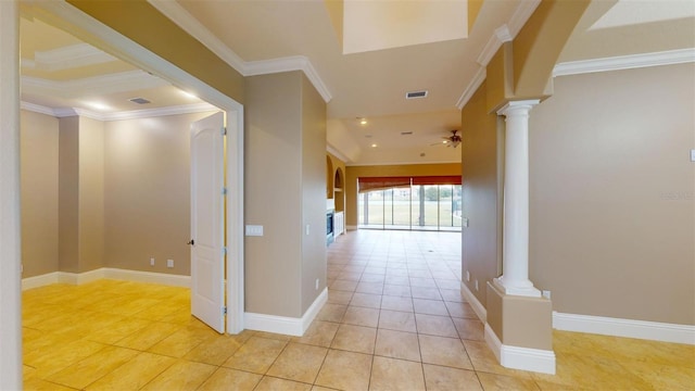 corridor featuring light tile patterned floors, ornamental molding, and decorative columns