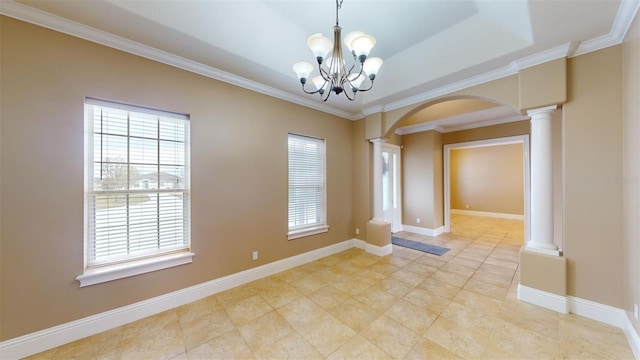 empty room with a healthy amount of sunlight, crown molding, and decorative columns