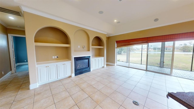 unfurnished living room with light tile patterned floors, built in features, and ornamental molding