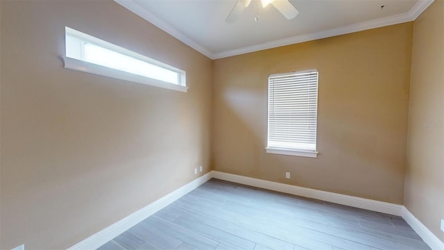 empty room with ceiling fan, light wood-type flooring, a wealth of natural light, and ornamental molding