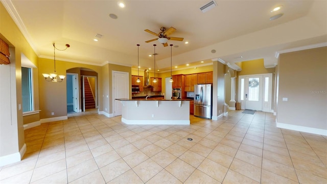 kitchen featuring light tile patterned floors, appliances with stainless steel finishes, ornamental molding, pendant lighting, and ceiling fan with notable chandelier