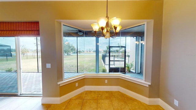 unfurnished dining area with tile patterned floors and an inviting chandelier