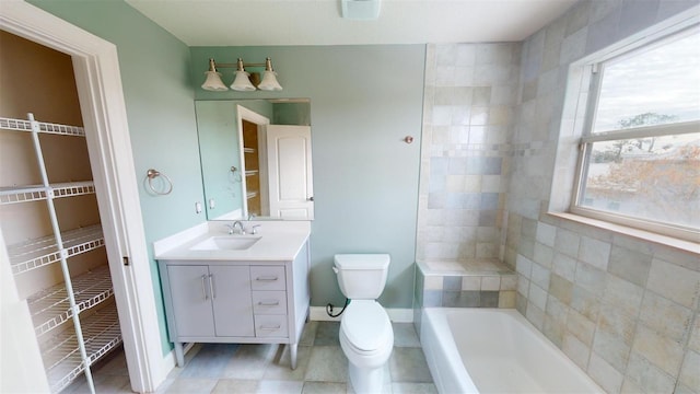 bathroom with toilet, a tub, and vanity