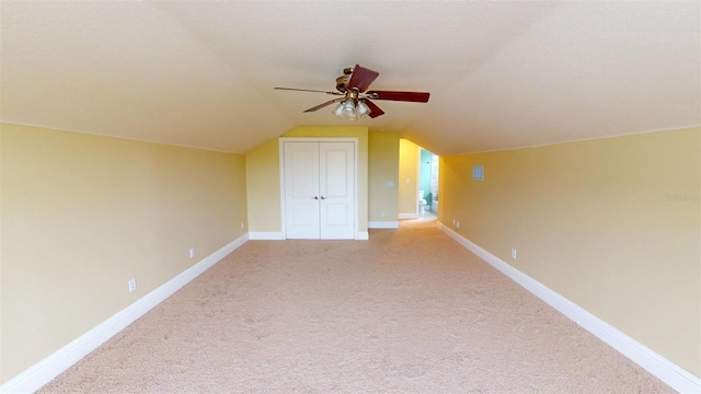 bonus room with ceiling fan, light carpet, and lofted ceiling