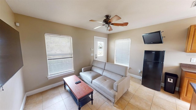 tiled living room with ceiling fan