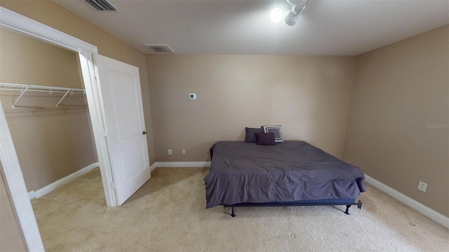 bedroom with light carpet and a closet