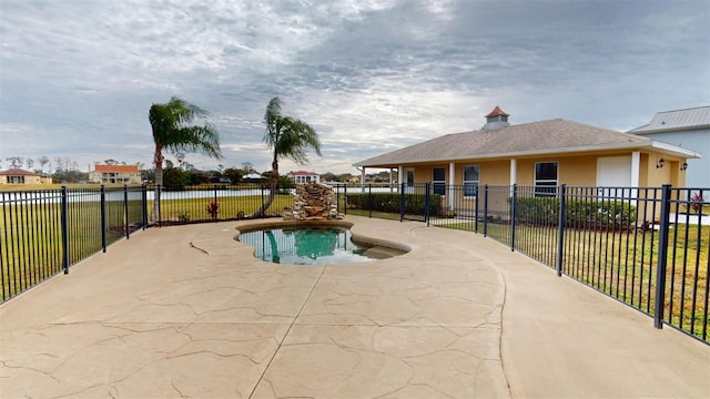 view of pool featuring a water view and a patio