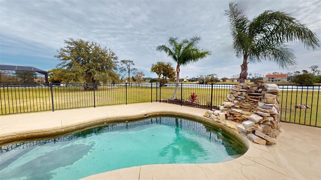 view of pool featuring a lawn and a patio area