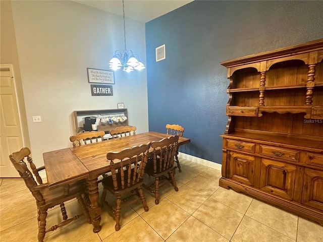 tiled dining room with a notable chandelier