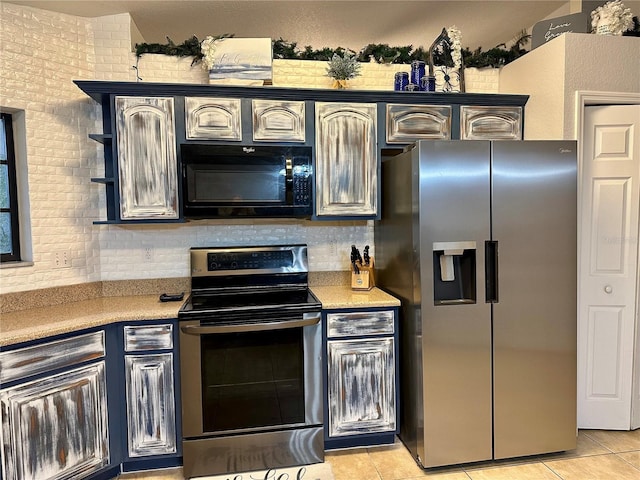 kitchen with appliances with stainless steel finishes and light tile patterned flooring