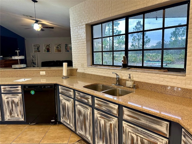 kitchen with light stone countertops, brick wall, dishwasher, sink, and light tile patterned flooring