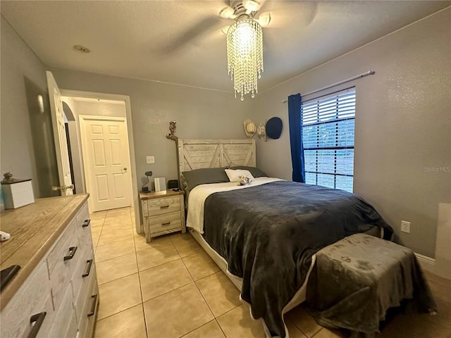 bedroom with ceiling fan and light tile patterned floors