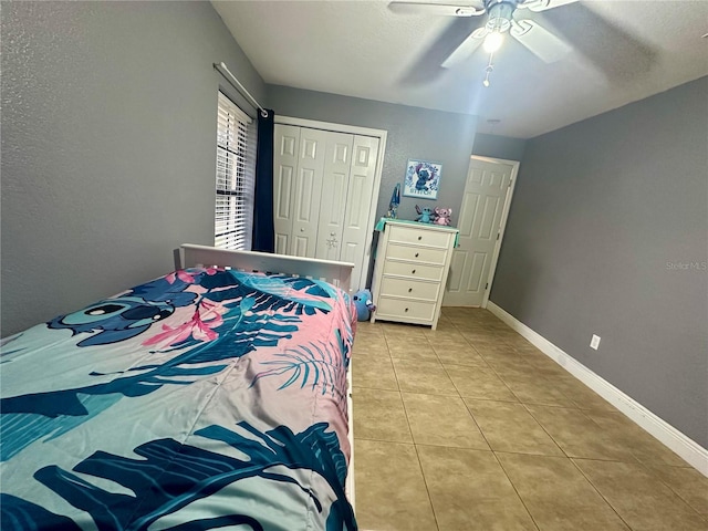 tiled bedroom with a closet and ceiling fan