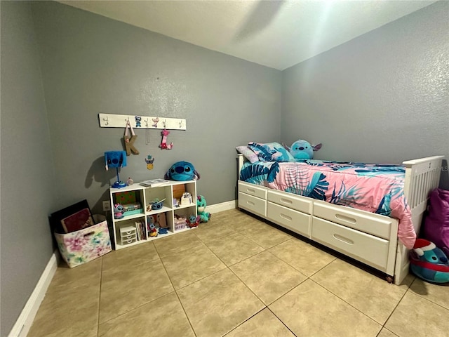 tiled bedroom featuring ceiling fan