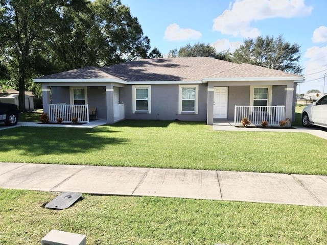 ranch-style house featuring a front yard and covered porch