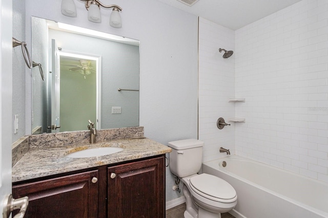 full bathroom with vanity, tiled shower / bath combo, and toilet