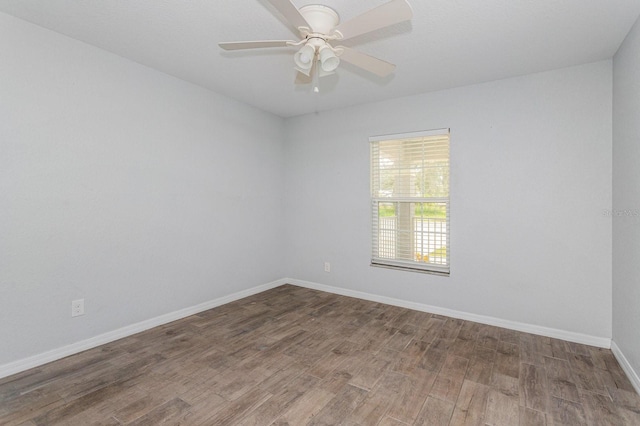 spare room with hardwood / wood-style flooring and ceiling fan