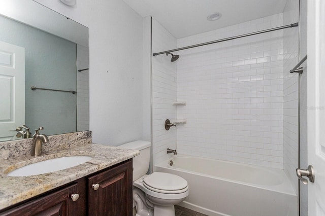 full bathroom featuring vanity, tiled shower / bath combo, and toilet