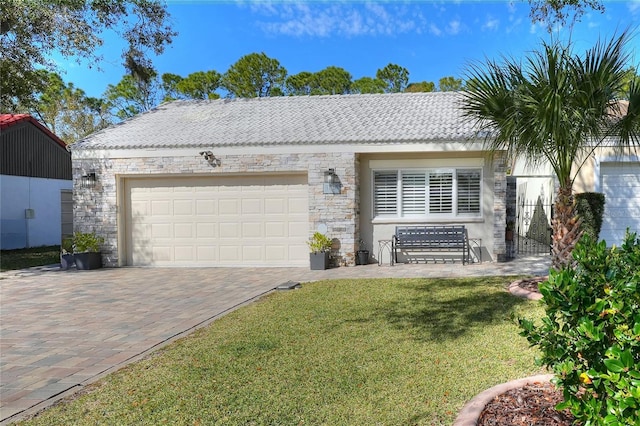 ranch-style home featuring a garage and a front lawn