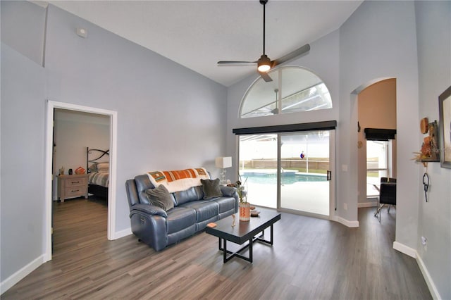 living room with ceiling fan, wood-type flooring, and high vaulted ceiling