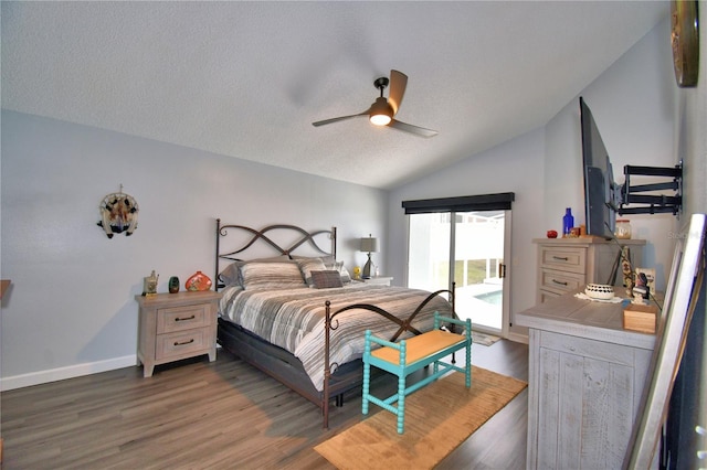 bedroom with vaulted ceiling, hardwood / wood-style floors, access to exterior, ceiling fan, and a textured ceiling