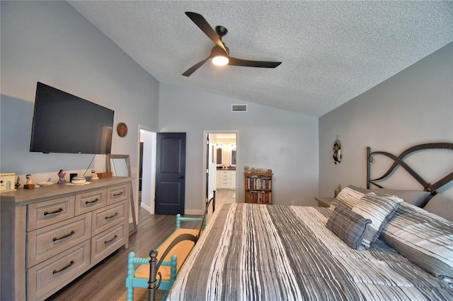 bedroom with dark wood-type flooring, ceiling fan, connected bathroom, and a textured ceiling