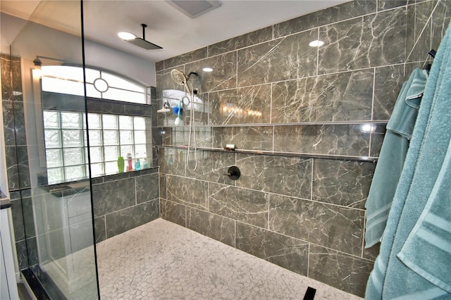 bathroom with a tile shower