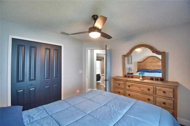 bedroom with ceiling fan, a closet, and a textured ceiling