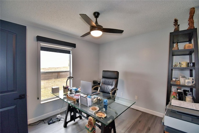 office space with hardwood / wood-style flooring, a textured ceiling, and ceiling fan