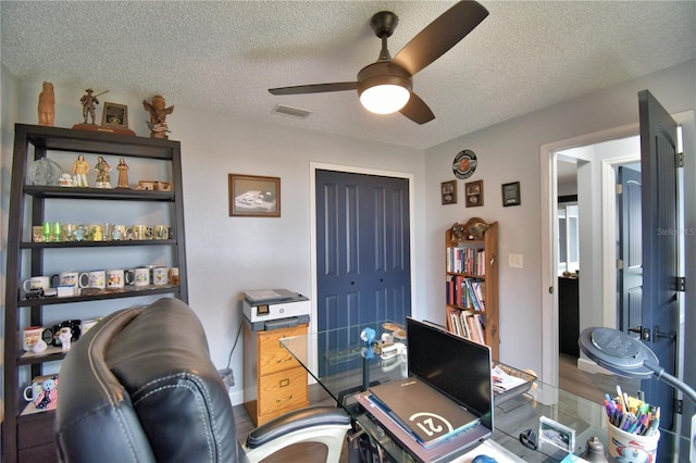 office area featuring ceiling fan, hardwood / wood-style floors, and a textured ceiling