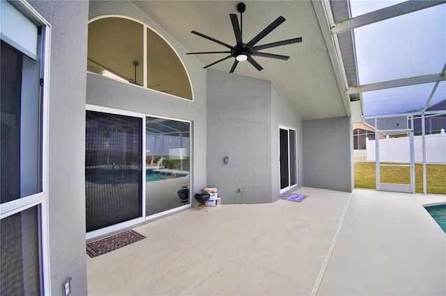 view of patio featuring a fenced in pool and ceiling fan