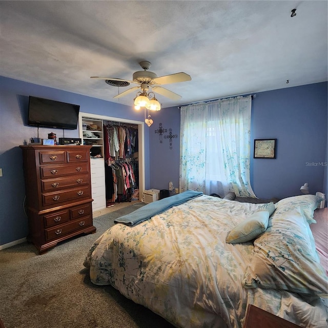 bedroom with ceiling fan, light carpet, and a closet