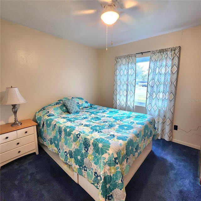 bedroom featuring ceiling fan and dark colored carpet