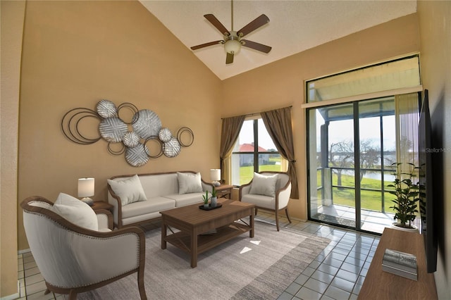 living room with ceiling fan, high vaulted ceiling, and light tile patterned floors