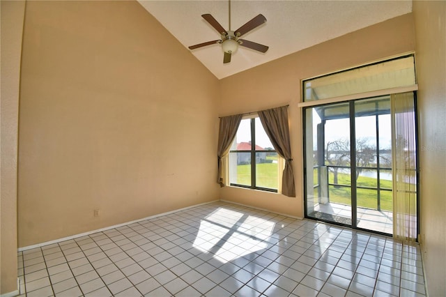 unfurnished room with ceiling fan, high vaulted ceiling, and light tile patterned floors